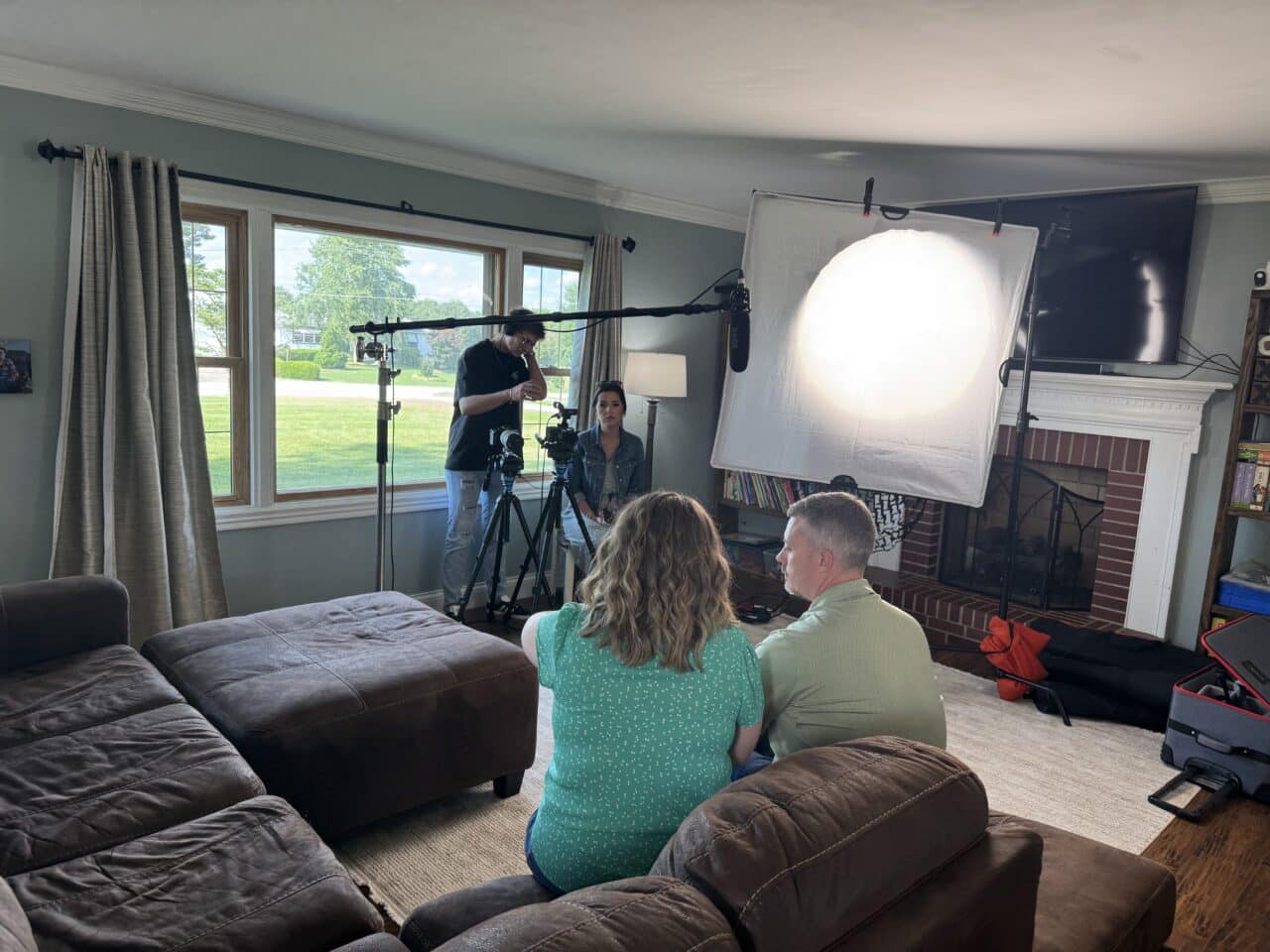 Wonder Boy Media videographer setting up book lighting for a corporate video interview in Owensboro Kentucky.